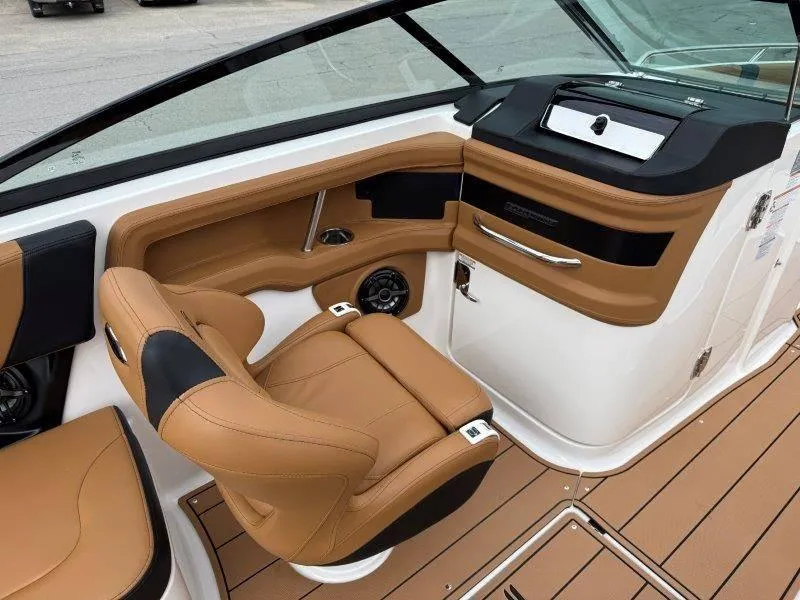 Slide: The Image of 2022 Chaparral 287 SSX boat interior with tan leather seating and modern dashboard. - 49