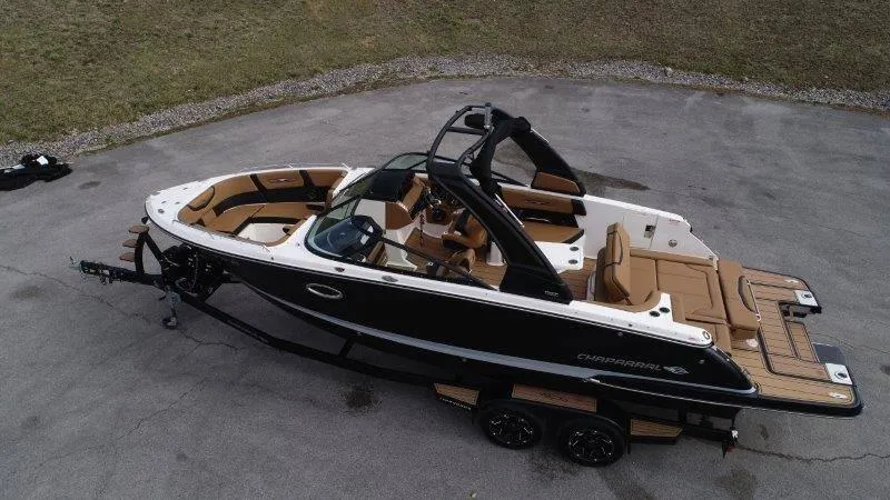 Slide: The Image of 2022 Chaparral 287 SSX boat on trailer, black and white exterior, brown interior. - 6