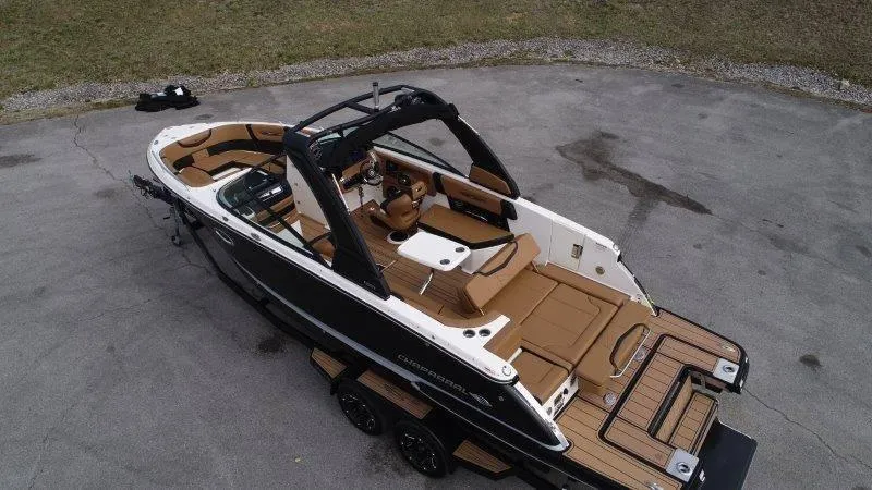 Slide: The Image of 2022 Chaparral 287 SSX boat with sleek design and spacious interior on a trailer. - 8