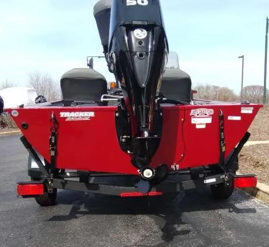Slide: The Image of 2025 Tracker Bass Tracker Classic XL boat, rear view, red hull, outboard motor. - 4