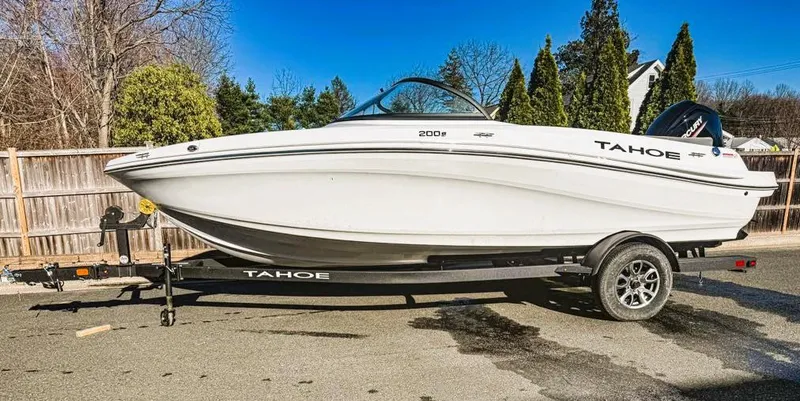 Slide: The Image of 2025 Tahoe 200 S boat on trailer, parked outdoors, sunny day. - 10