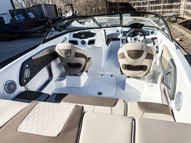 Slide: The Image of 2025 Tahoe 200 S boat interior with modern seating and steering wheel. - 2