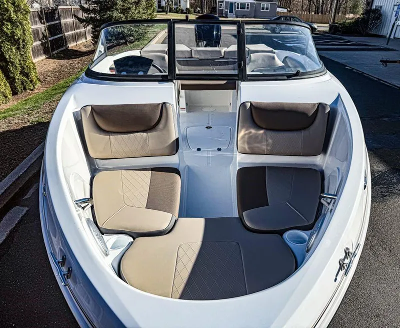 Slide: The Image of 2025 Tahoe 200 S boat interior with beige seating and windshield. - 3