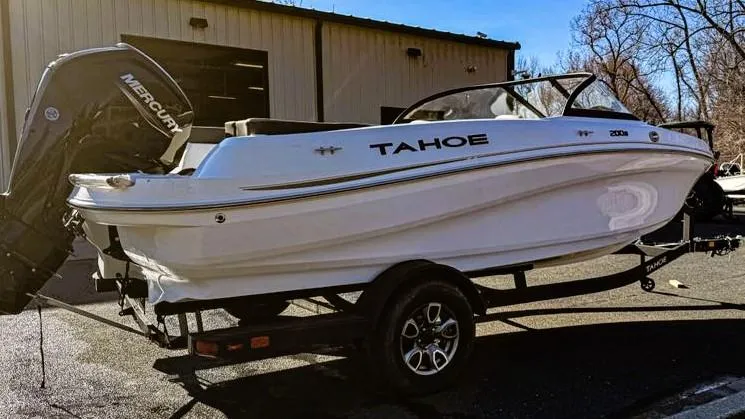 Slide: The Image of 2025 Tahoe 200 S boat on trailer, parked outdoors near a building. - 4