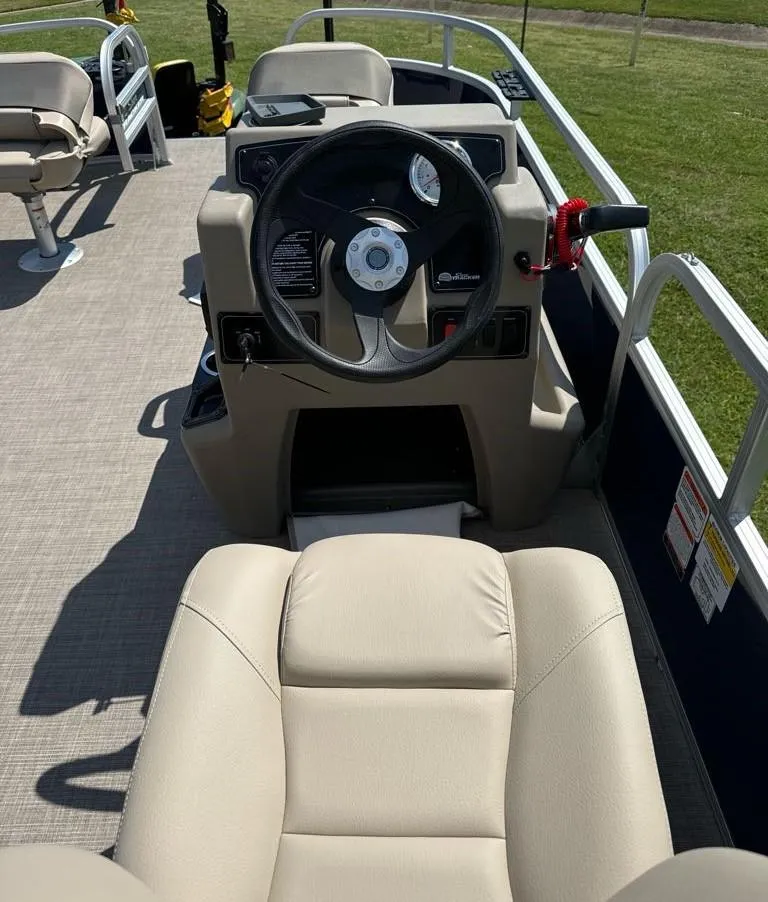 Slide: The Image of 2025 Sun Tracker Bass Buggy 16 XL Select pontoon boat interior with steering console and seating. - 7