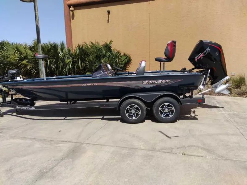 The Image of 2025 Ranger ALPHA 208 boat on trailer, parked outdoors, side view. - 0