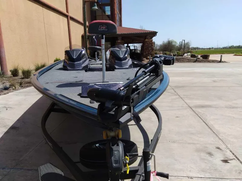 Slide: The Image of 2025 Ranger ALPHA 208 boat parked outdoors on concrete surface. - 1