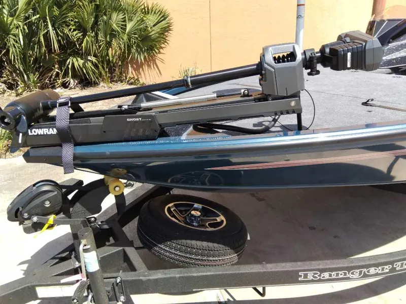 Slide: The Image of 2025 Ranger ALPHA 208 boat on trailer with Lowrance equipment, parked outdoors. - 2