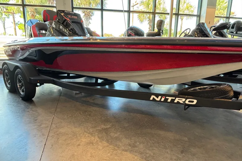 The Image of 2025 Nitro Z19 boat with sleek red design on display indoors. - 0