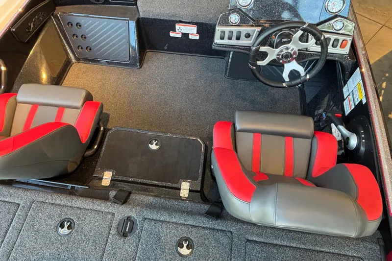 Slide: The Image of Interior of 2025 Nitro Z19 boat with red and gray seating and modern dashboard. - 2