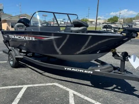 Slide: The Image of 2025 Tracker Pro Guide V-175 Combo boat on trailer in parking lot. - 2