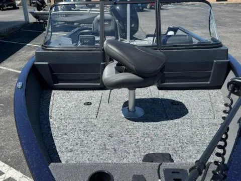 Slide: The Image of 2025 Tracker Pro Guide V-175 Combo boat with seating and windshield, parked outdoors. - 8