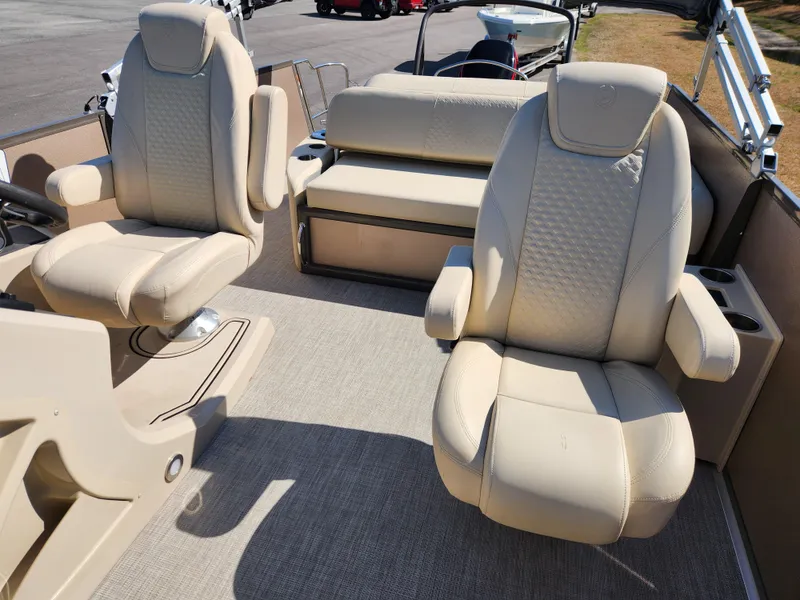 Slide: The Image of 2020 Premier 230 Sun Station boat interior with beige seating and carpeted floor. - 10
