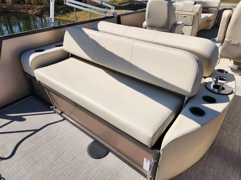 Slide: The Image of Premier 230 Sun Station 2020 boat interior with beige seating and cup holders. - 14