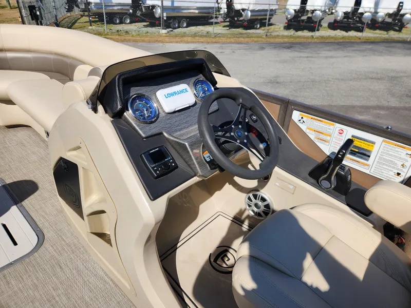 Slide: The Image of 2020 Premier 230 Sun Station boat dashboard with steering wheel and navigation system. - 15