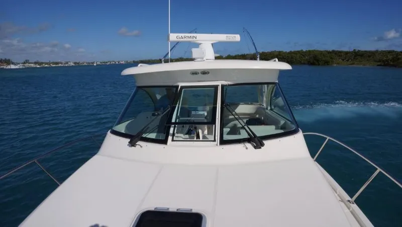 Slide: The Image of 2014 Pursuit OS 345 Offshore boat cruising on clear blue water. - 10