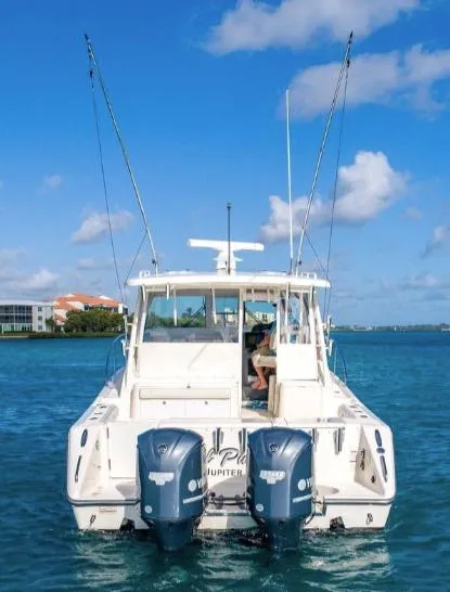 Slide: The Image of 2014 Pursuit OS 345 Offshore boat with dual engines on blue water. - 16