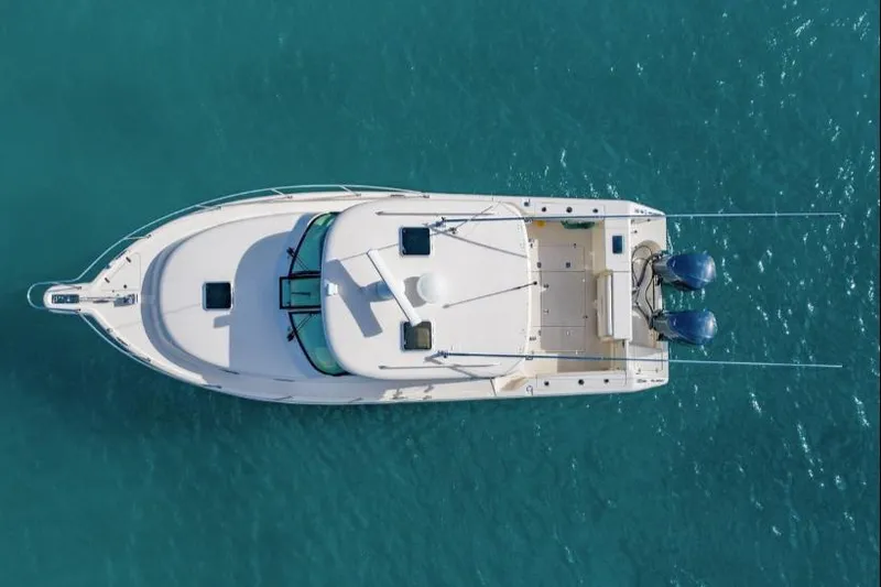 Slide: The Image of Aerial view of 2014 Pursuit OS 345 Offshore boat on clear blue water. - 2