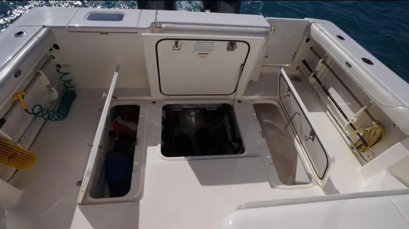 Slide: The Image of 2014 Pursuit OS 345 Offshore boat deck with open storage compartments. - 21