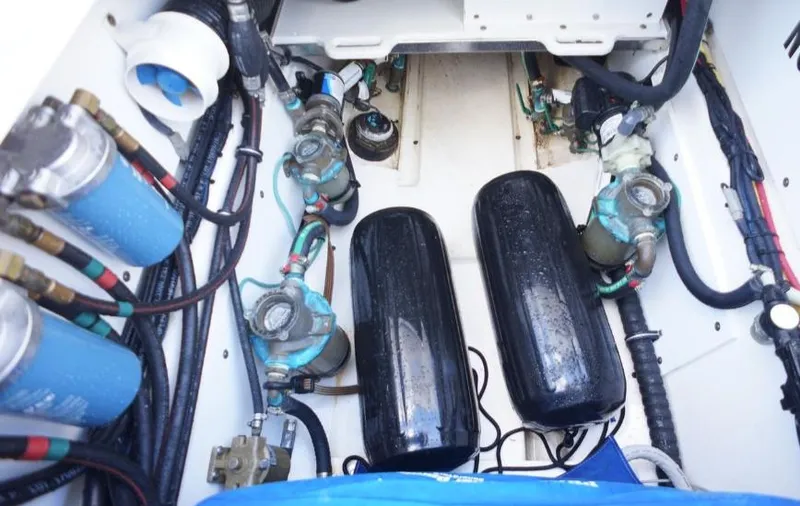 Slide: The Image of Engine compartment of 2014 Pursuit OS 345 Offshore boat, featuring various mechanical components. - 22