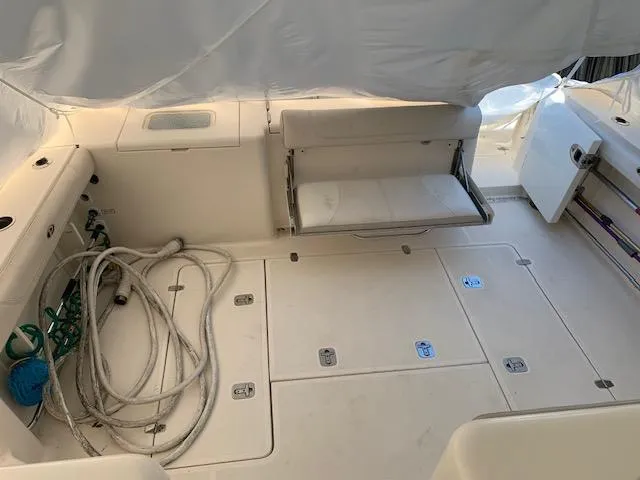 Slide: The Image of 2014 Pursuit OS 345 Offshore boat interior with seating and storage compartments. - 33