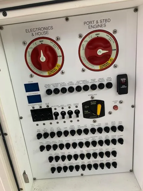 Slide: The Image of Control panel of a 2014 Pursuit OS 345 Offshore boat with switches and dials. - 34