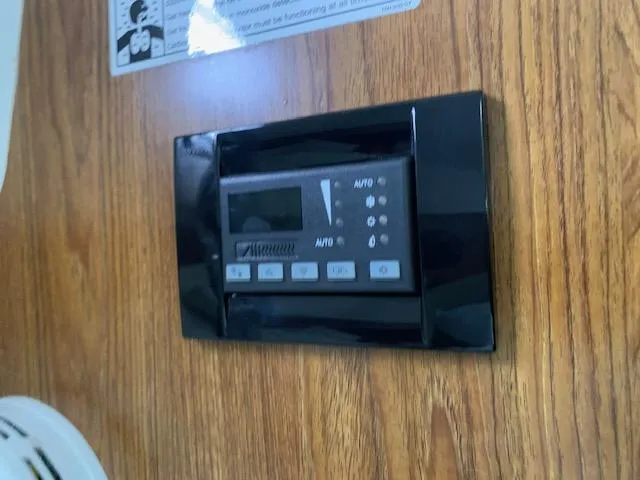 Slide: The Image of Control panel on 2014 Pursuit OS 345 Offshore boat, mounted on wood panel. - 49