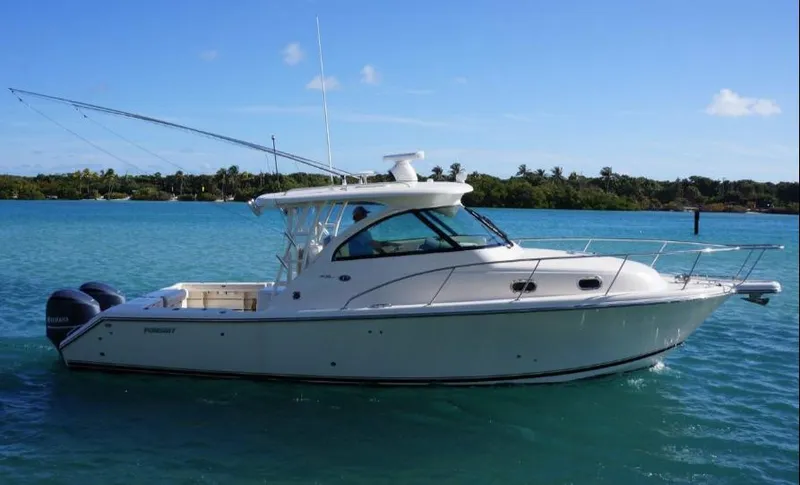 Slide: The Image of 2014 Pursuit OS 345 Offshore boat on clear blue water. - 5