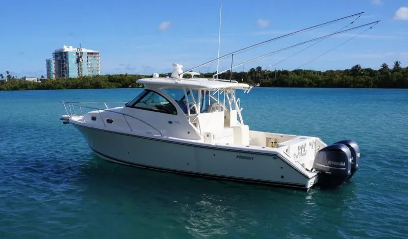 Slide: The Image of 2014 Pursuit OS 345 Offshore boat on clear blue water, with a scenic background. - 6