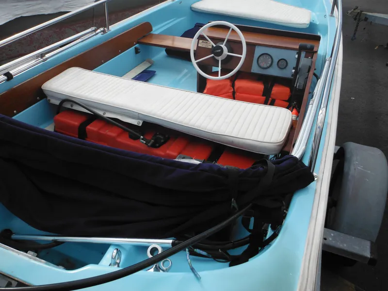 Slide: The Image of 1998 Boston Whaler 13 Sport boat interior with white seating and orange life jackets. - 10