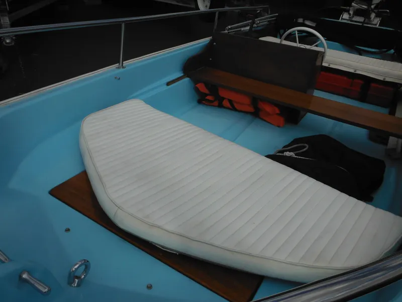 Slide: The Image of 1998 Boston Whaler 13 Sport interior with white seating and safety equipment. - 13
