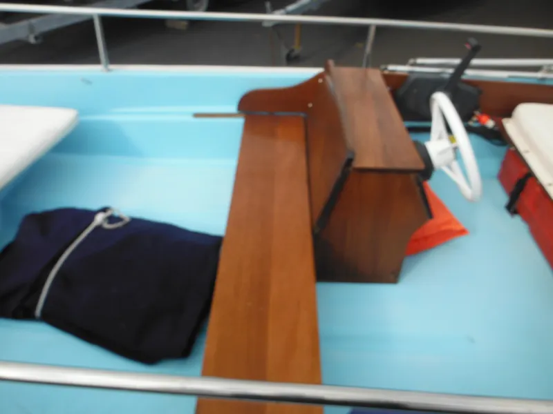 Slide: The Image of 1998 Boston Whaler 13 Sport interior with wooden bench and steering wheel. - 15