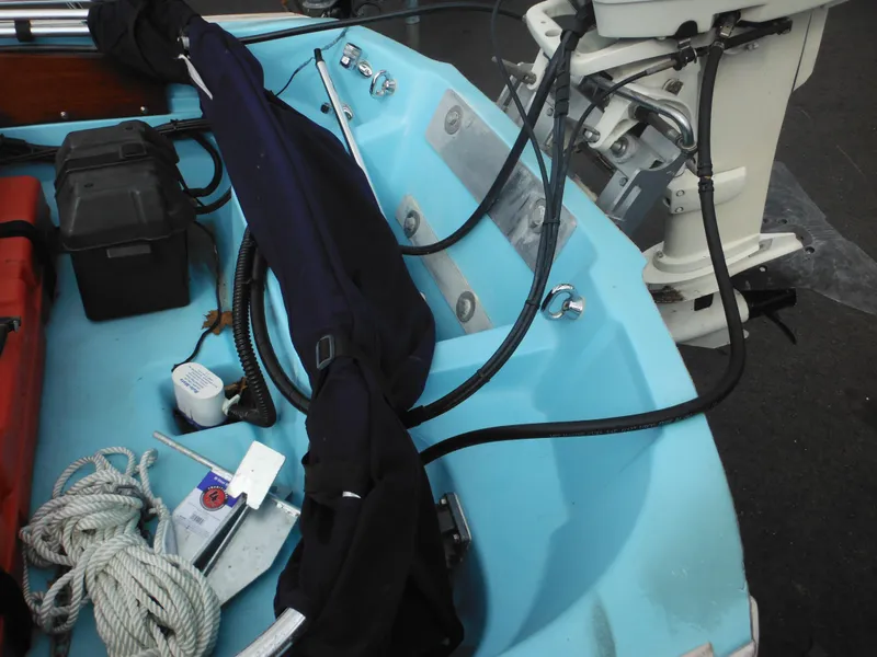 Slide: The Image of 1998 Boston Whaler 13 Sport interior with equipment and outboard motor. - 18