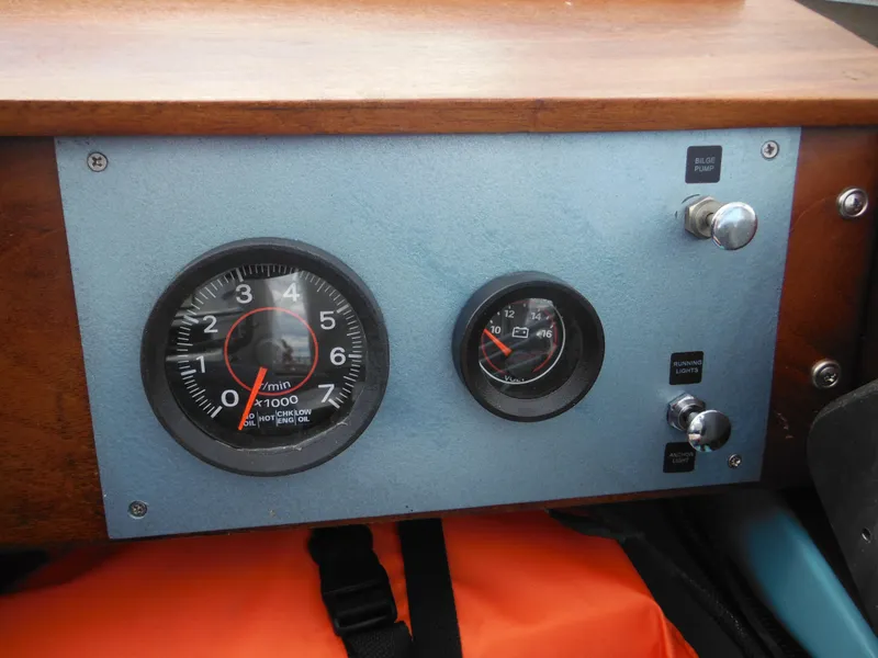 Slide: The Image of Dashboard of a 1998 Boston Whaler 13 Sport boat with gauges and controls. - 21