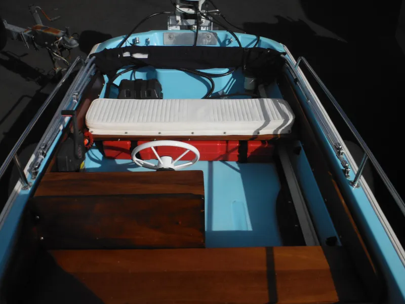 Slide: The Image of 1998 Boston Whaler 13 Sport boat interior with blue and wooden accents. - 24
