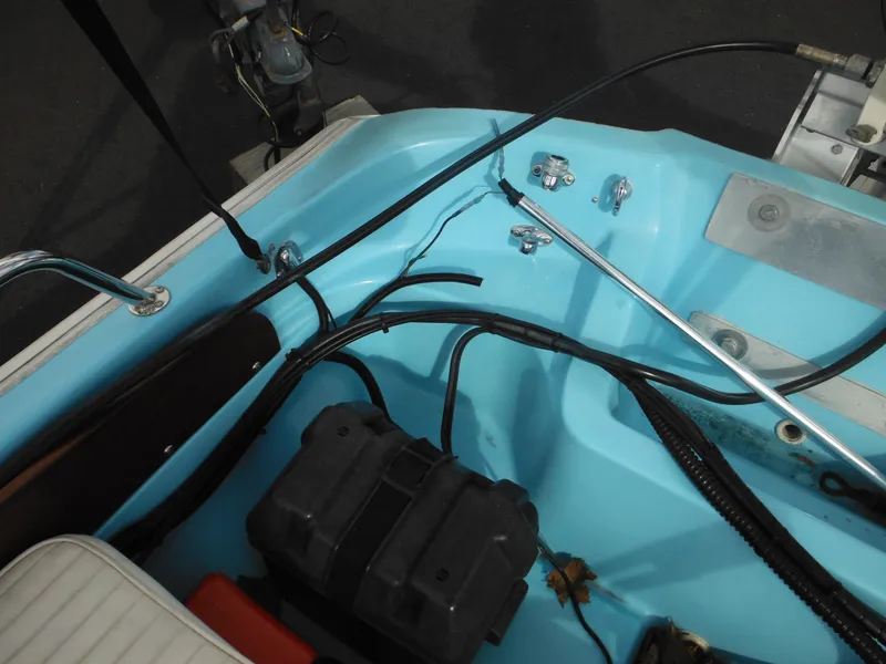 Slide: The Image of Interior view of a 1998 Boston Whaler 13 Sport boat, showcasing wiring and components. - 27