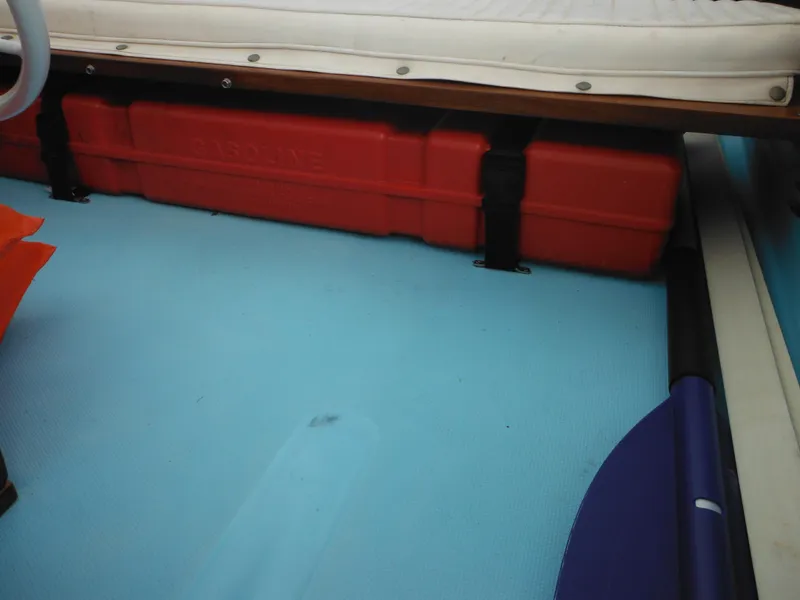 Slide: The Image of 1998 Boston Whaler 13 Sport interior with red storage box and blue floor. - 29