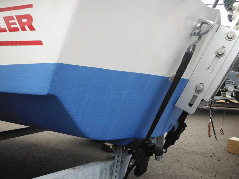 Slide: The Image of 1998 Boston Whaler 13 Sport boat hull with blue and white design. - 31