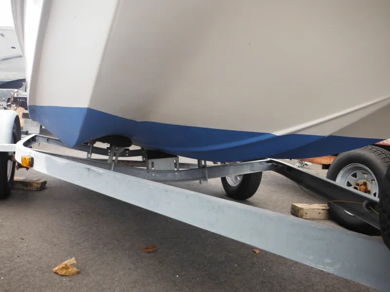 Slide: The Image of 1998 Boston Whaler 13 Sport boat on trailer, showing hull and blue bottom paint. - 35