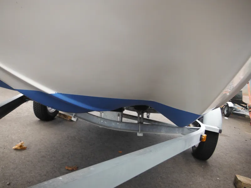 Slide: The Image of 1998 Boston Whaler 13 Sport boat on trailer, showing hull and wheels. - 36