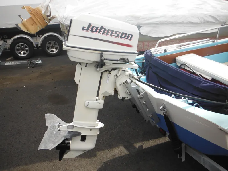 Slide: The Image of 1998 Boston Whaler 13 Sport with Johnson outboard motor, parked on a trailer. - 4