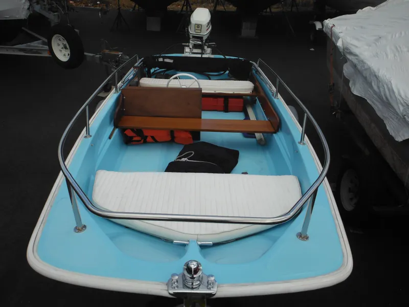 Slide: The Image of 1998 Boston Whaler 13 Sport boat with blue interior and wooden seating. - 40
