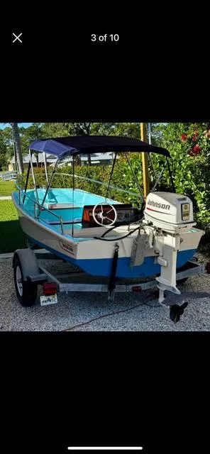 Slide: The Image of 1998 Boston Whaler 13 Sport boat with Johnson outboard motor on a trailer. - 42
