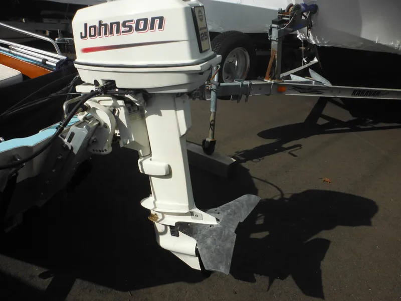 Slide: The Image of Outboard motor on a 1998 Boston Whaler 13 Sport boat, featuring a Johnson engine. - 7