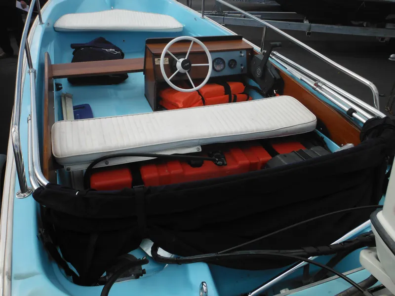 Slide: The Image of 1998 Boston Whaler 13 Sport boat interior with steering wheel and seating. - 9