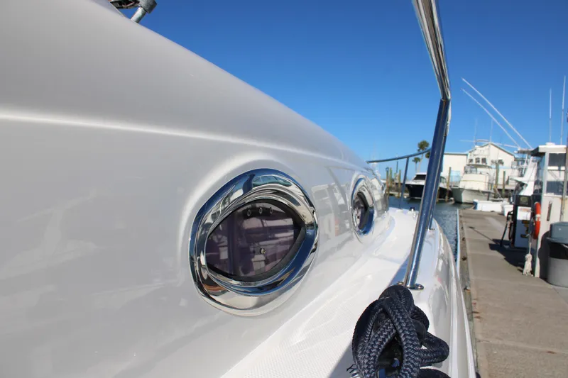 Slide: The Image of Close-up of 2005 Sea Ray 340 Sundancer yacht with chrome portholes and dock view. - 11
