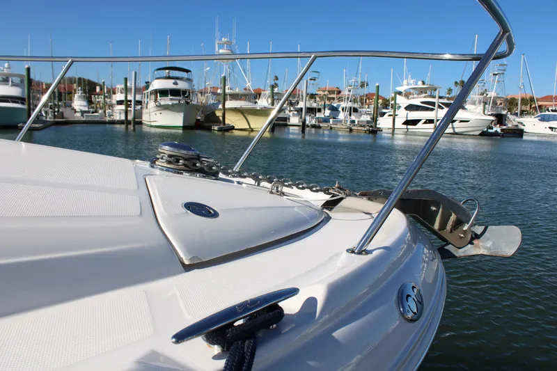 Slide: The Image of 2005 Sea Ray 340 Sundancer yacht docked in a marina, surrounded by other boats. - 12
