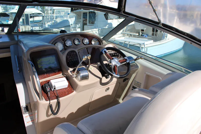 Slide: The Image of Helm of 2005 Sea Ray 340 Sundancer with steering wheel, gauges, and controls. - 14