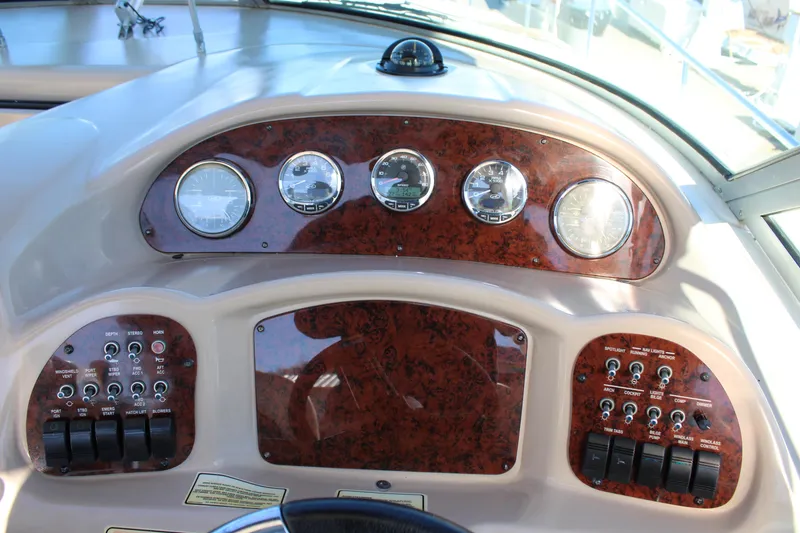 Slide: The Image of Dashboard of a 2005 Sea Ray 340 Sundancer boat with gauges and controls. - 18