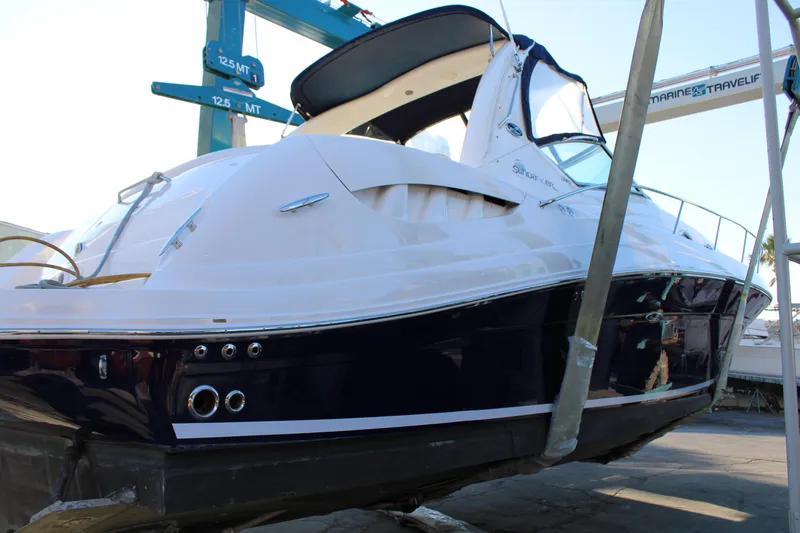 Slide: The Image of 2005 Sea Ray 340 Sundancer yacht on a lift, showcasing sleek design and modern features. - 2